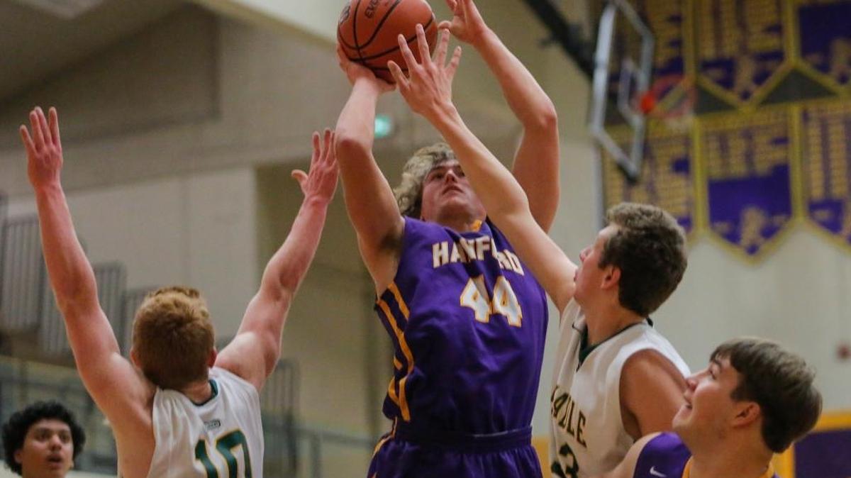 Shadle Park's Brock Leinweber (10) and Carson Doyle (3) guard Hanford's Blake VanderTop (44) during a boys basketball game Thursday at Hanford High School in Richland. Hanford won the game 68-59.