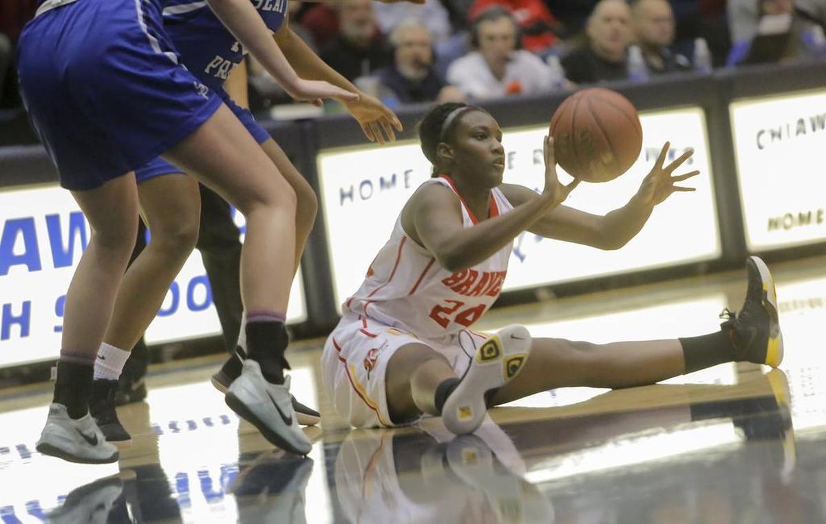 Kamiakin’s Oumou Toure (24) passes after scrambling to the floor for a loose ball during the Braves state regional win over Seattle Prep in Kennewick. The two-time MCC Player of the Year, Toure will be one of the leaders of the Tri-City girls team in Saturday’s SWX All-Star Classic at Kamiakin High School.