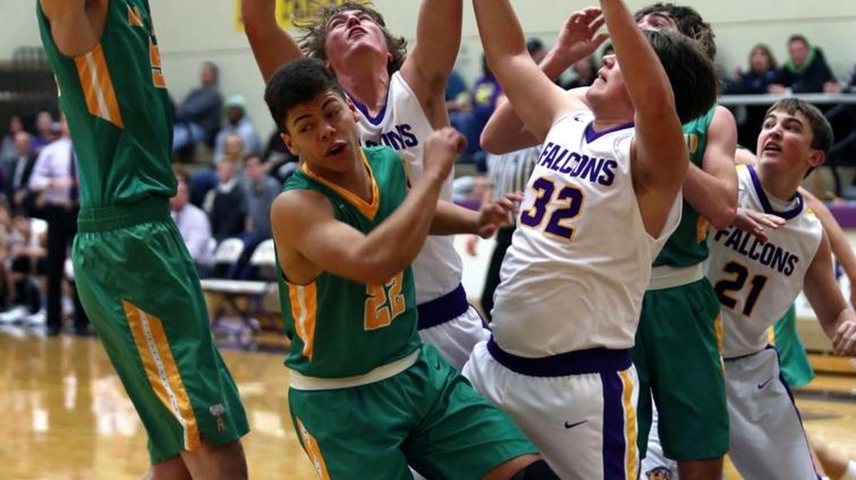 Richland’s Riley Sorn, left, pulls down a rebound over teammate Nathan Mitchell (22) as well as Hanford’s Blake Vander Top and Conner Milliken (32) during Friday’s Mid-Columbia Conference game at Hanford High School. See more photos at www.tricityherald.com.
