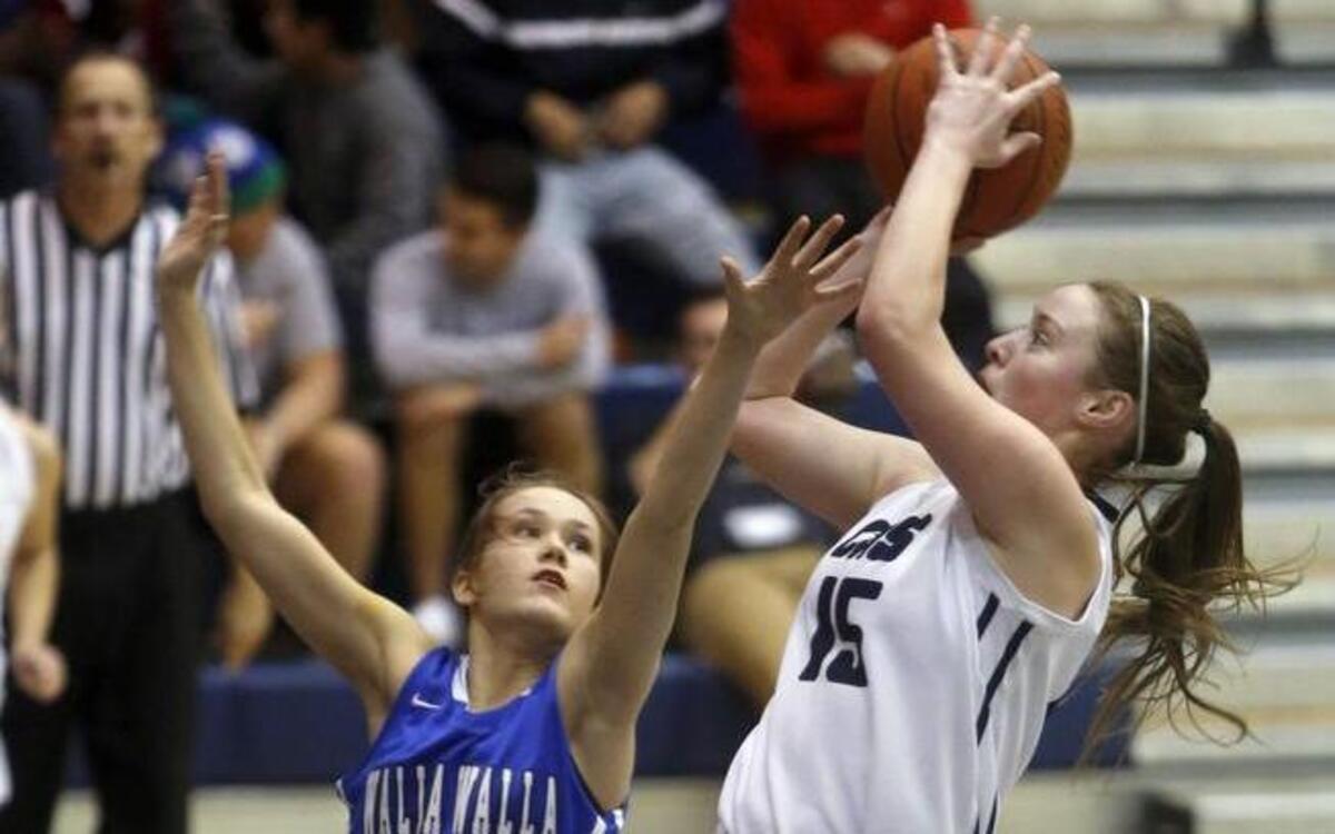 Chiawana High School’s Adelina Guzman (15) puts up a shot over Walla Walla’s Olivia Reardon (30) on Saturday night in Pasco. The Riverhawks won 95-64.