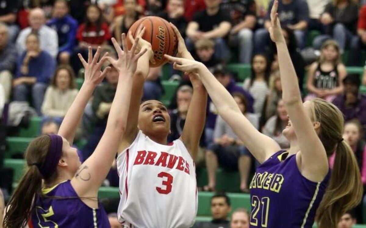 Kamiakin’s Symone Brown (3) puts up a shot over Columbia River’s Katie Kolbe (21) and Maddy Kessi during Saturday’s Class 3A state regional at Richland High School. The Braves found out Sunday they will play Edmonds-Woodway in the state quarterfinals Thursday in Tacoma.
