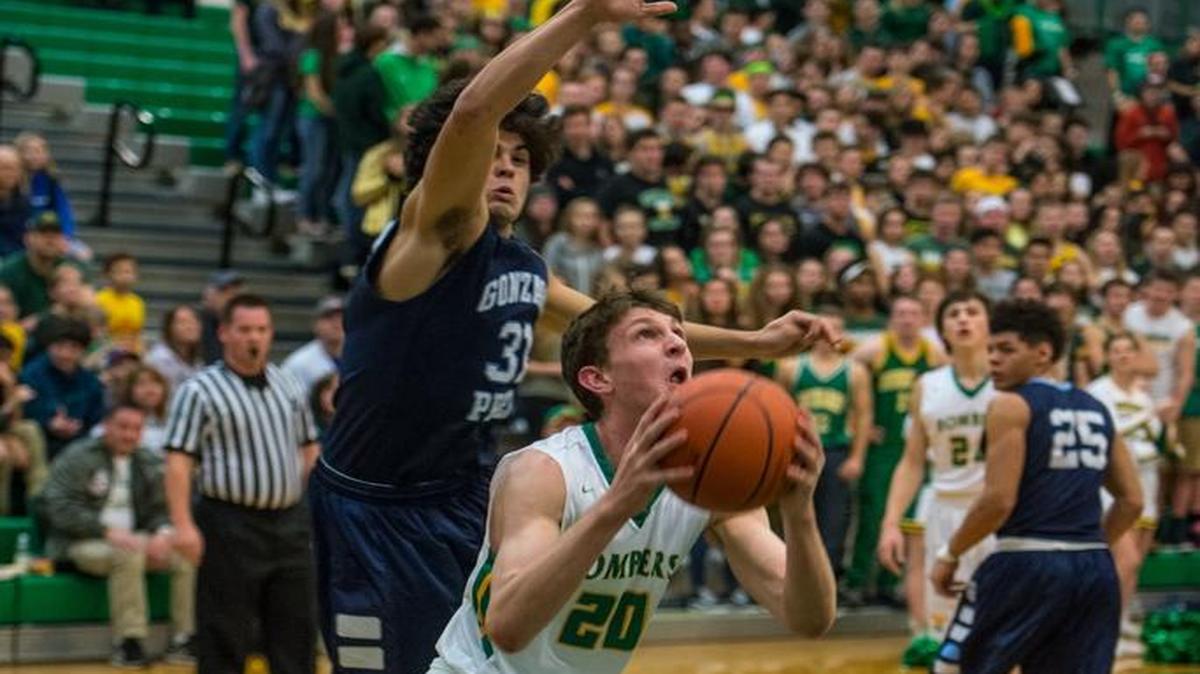 Richland's Tyler Kurtz prepares to go in for a layup while Gonzaga Prep's Anton Watson looms overhead during the MCC-GSL sub-regional championship game Feb. 18 at Richland High School. Gonzaga Prep advanced to to the state regionals with an 81-80 win in triple overtime, but the game didn’t count toward the RPI rating for either team since the tournament seedings locked at the end of the regular season. The WIAA announced Wednesday that this will change in seasons to come.