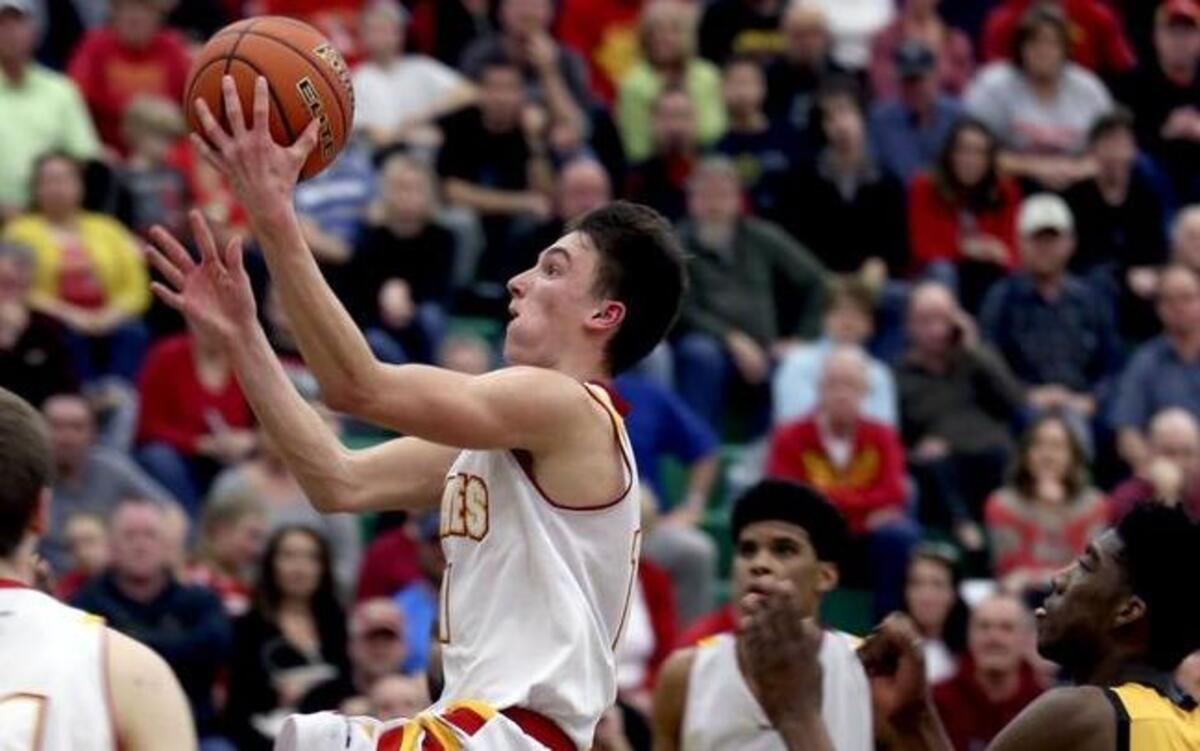 Kamiakin Garrett Paxton (11) puts up a basket during Saturday’s Class 3A state regional game against Lincoln at Richland High School.