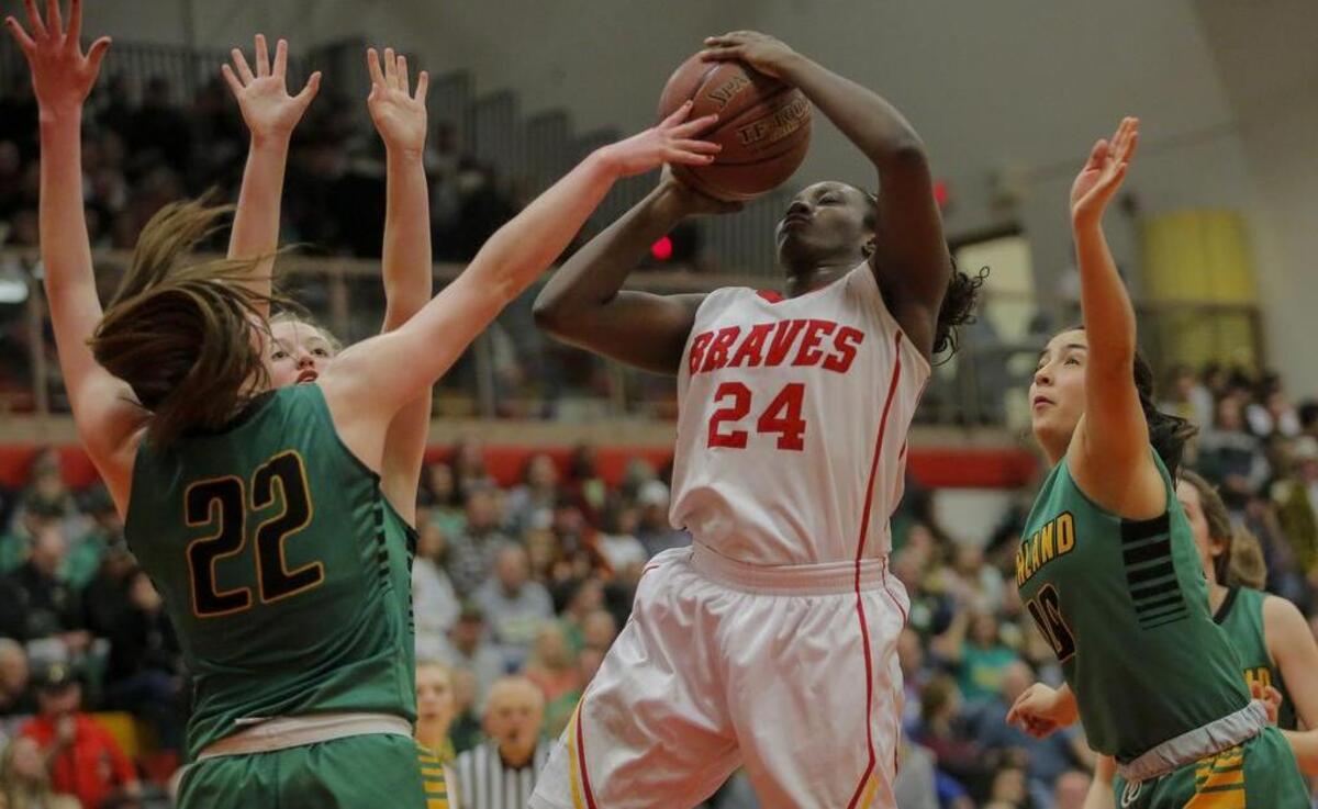Richland defenders Nicole Gall (22), Gracie Pierce (50) and Emily Garza (10) circle around Kamiakin’s Oumou Toure (24) as she takes a shot during a Mid-Columbia Conference girls basketball game Saturday at Kamiakin High School in Kennewick. Toure scored 28 points to lead Kamiakin to a 78-51 victory.