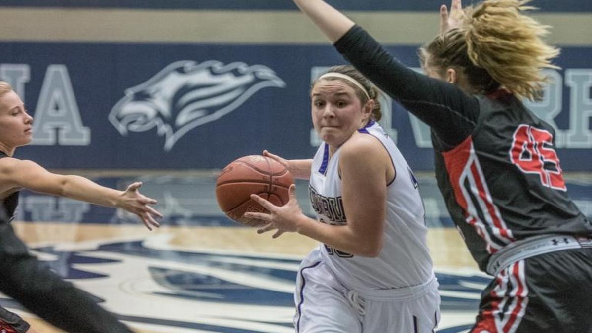 Columbia-Burbank senior Taylor Turner, center, drives in for a layup, while being defended by Seattle Christian’s Julia Seibel.
