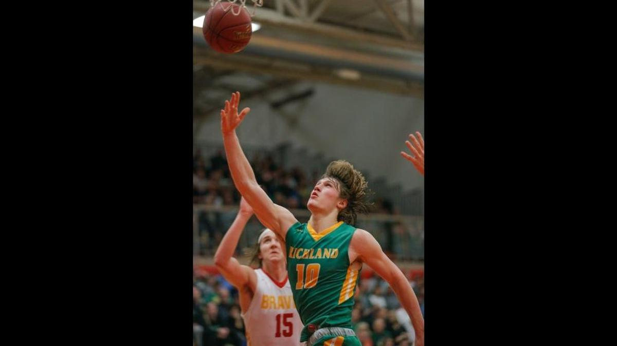 Richland’s Cody Sanderson (10), shooting a layup over Kamiakin’s Payton Flynn (15) during an MCC game earlier this season, starts at guard for the Bombers basketball team and also played wide receiver and defensive back for the school’s state title-touting football squad. If the 22-1 Richland boys basketball team wins a state title at next week’s tournament in Tacoma, it will be the first time a school has won WIAA 4A state football and boys basketball state championships in the same academic year.