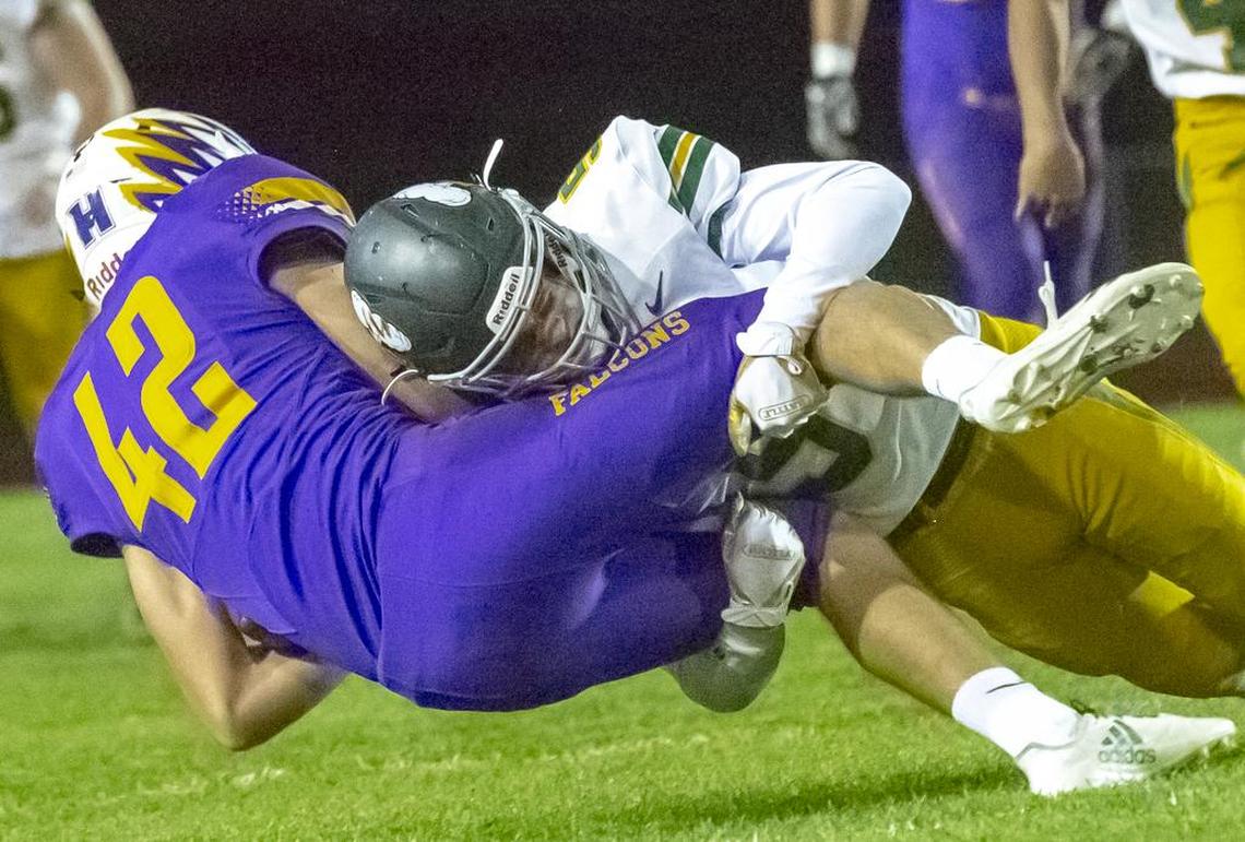 Richland’s Ben Fewel, right, takes down Hanford’s Luke Sutey (42) during a Mid-Columbia Conference high school football game Friday at Fran Rish Stadium in Richland. Richland won 34-24.