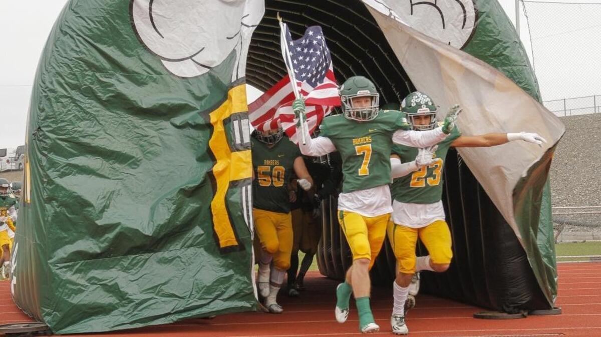 Richland’s Adam Weissenfels (7), carrying the U.S. flag onto the field before a 2017 4A state semifinal football game against Central Valley, accepted his appointment into the United States Naval Academy on Wednesday.
