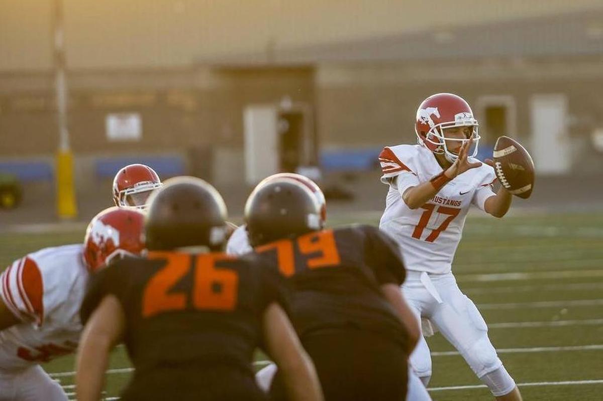 Prosser quarterback Will Weinmann (17) takes a snap during a game against Kennewick High School on Friday at Lampson Stadium. Prosser defeated Kennewick 22-14.