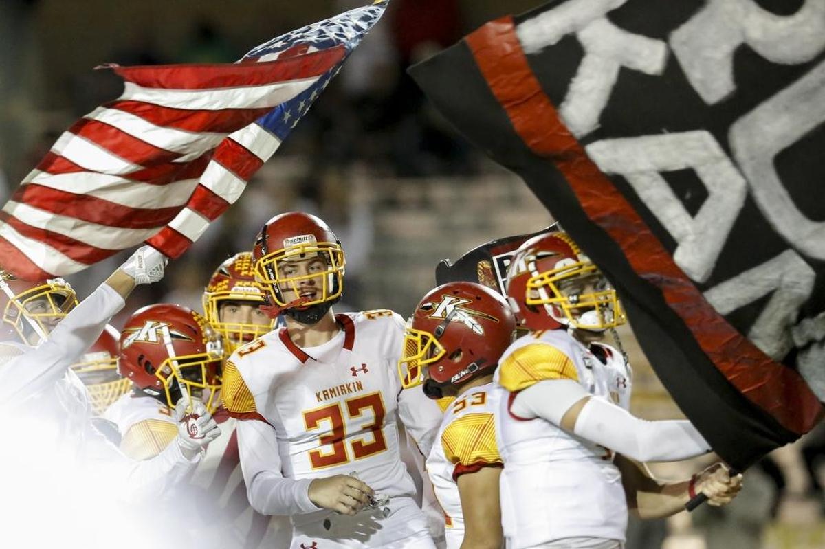 Kamiakin's football team runs out on to the field after the National Anthem at Fran Rish Stadium on Friday before the start of a Mid-Columbia football game against Richland. The Braves were told the anthem would be at 7:00 p.m., but were misinformed.