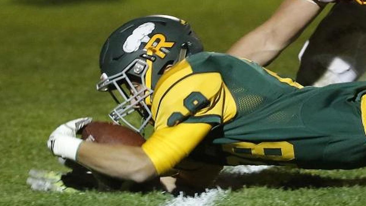 Richland’s McClain Elgin (28) stretches across the goal line for a touchdown during Friday night’s game against Kamiakin at Fran Rish Stadium in Richland. Kamiakin defender Logan Smith (8) pursues the play. See a photo gallery at tricityherald.com
