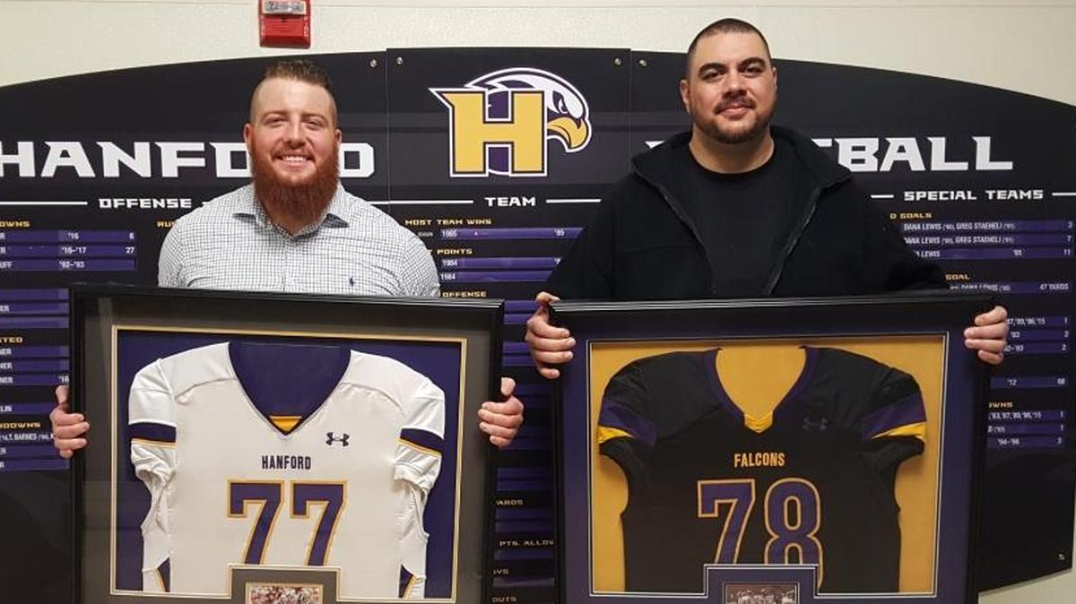 Former Hanford High football players Aaron Neary (left) and Mac Tuiaea had their numbers retired Friday by the school.