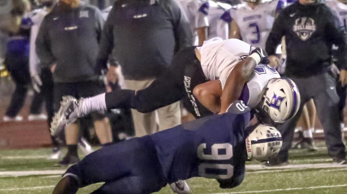 Chiawana’s AJ Vongphachanh (90) tackles Hermiston’s Wyatt Noland (32) as he runs with the ball during a Mid-Columbia Conference football game on Friday at Edgar Brown Stadium in Pasco. Chiawana won 34-10.