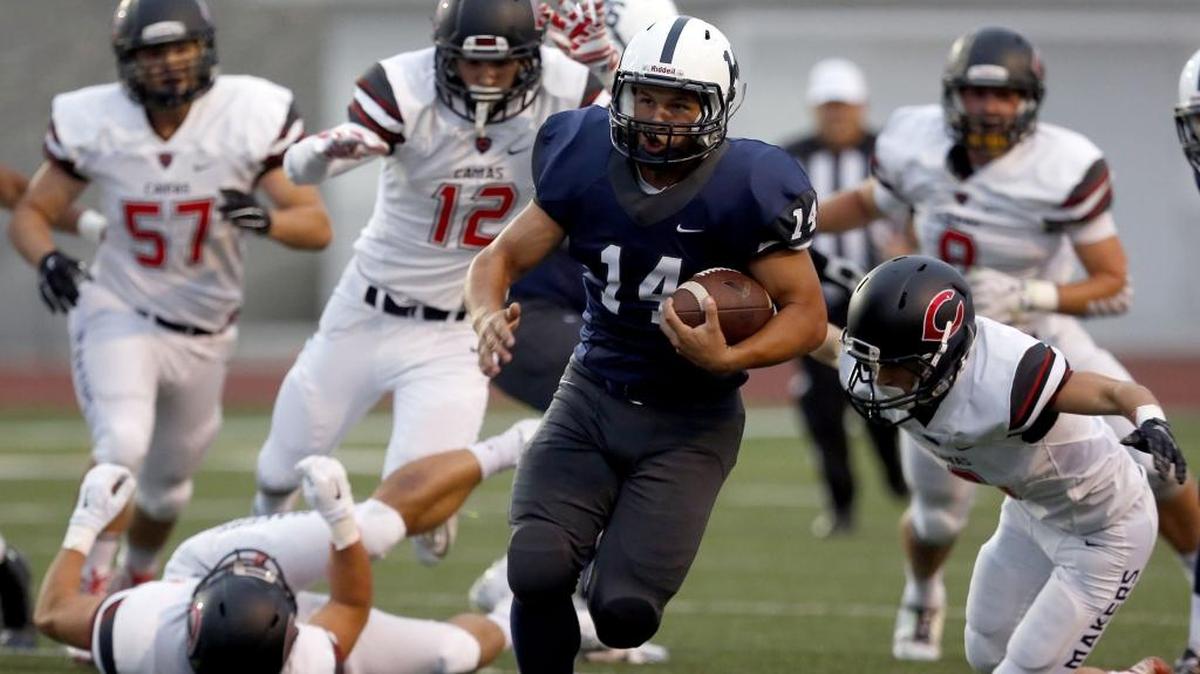 
Chiawana’s Andrew Vargas (14) carries the ball with plenty of Camas defenders giving chase during Friday’s game at Edgar Brown Stadium in Pasco.  See more photos at www.tricityherald.com.
