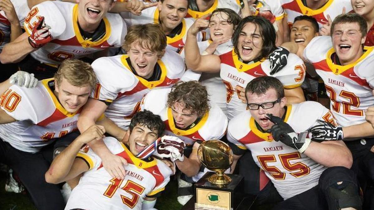 Members of the Kamiakin football team celebrate their 14-7 overtime win over O’Dea on Friday night in the Class 3A state championship at the Tacoma Dome.