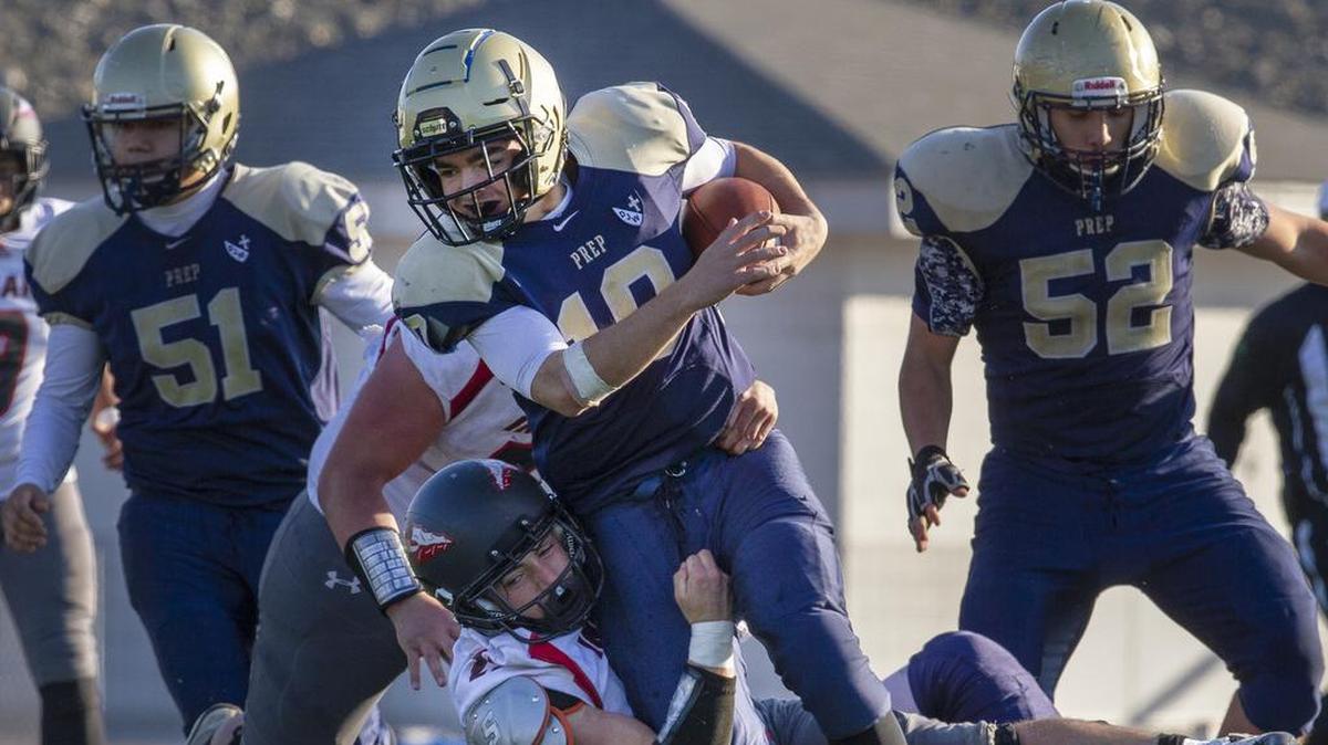 Tri-Cities Prep’s Zerek Baker (10) runs with the ball as Toledo’s Ethan Buck (23) tackles him during a playoff game on Saturday, Nov. 17, at Edgar Brown Stadium in Pasco. Toledo won 34-23.