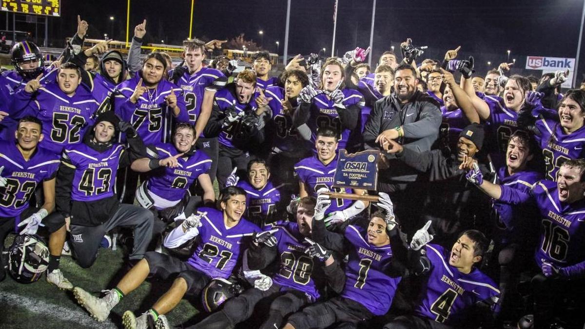 The Hermiston High School football team celebrates after beating Churchill 38-35 in the OSAA 5A championship game on Saturday at Hillsboro Stadium.