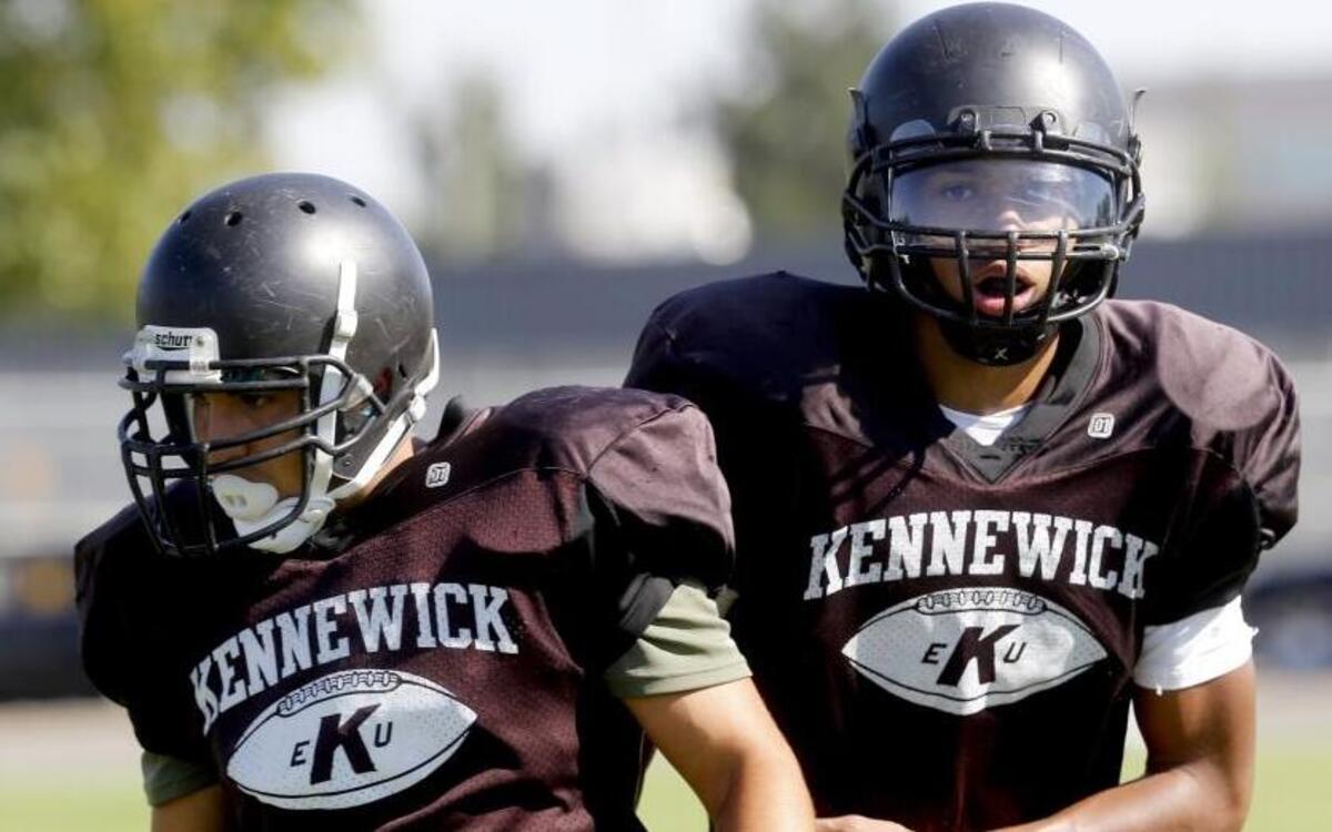 Kennewick’s Ronny Loomis, right, and Isaac Ruiz run through drills during Thursday’s practice. The pair will be a common sight for opposing defenses as the Lions are stacked to run the ball.