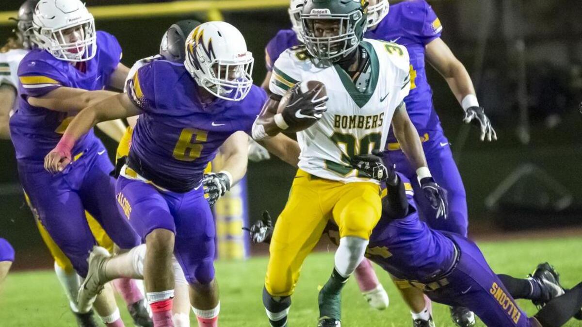 Richland running back Dhuanye Guice (38) works his way through the Hanford defense early on in Friday night’s Mid-Columbia Conference clash between the Bombers and Falcons at Fran Rish Stadium in Richland.