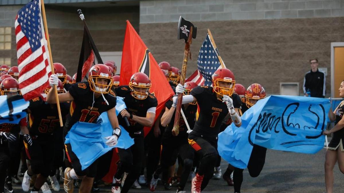 Kamiakin’s Champ Grayson (17), Payton Flynn (4) and Benson Smith (1) lead the Braves onto the field at Lampson Stadium before a Sept. 15 game against the Chiawana Riverhawks. Kamiakin will host Lakes at 1 p.m. Saturday in a winner-to-state, Week 10 playoff game.