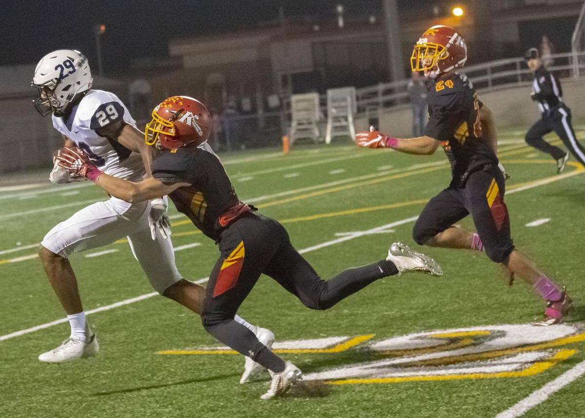 Chiawana’s Kobe Young (29) runs with the ball as Kamiakin’s defense Kelen Rutz (1) and Devyn Koonhuntod (24) attempt to stop him during a Mid-Columbia Conference high school football game at Lampson Stadium in Kennewick on Thursday. Chiawana won 42-0.
