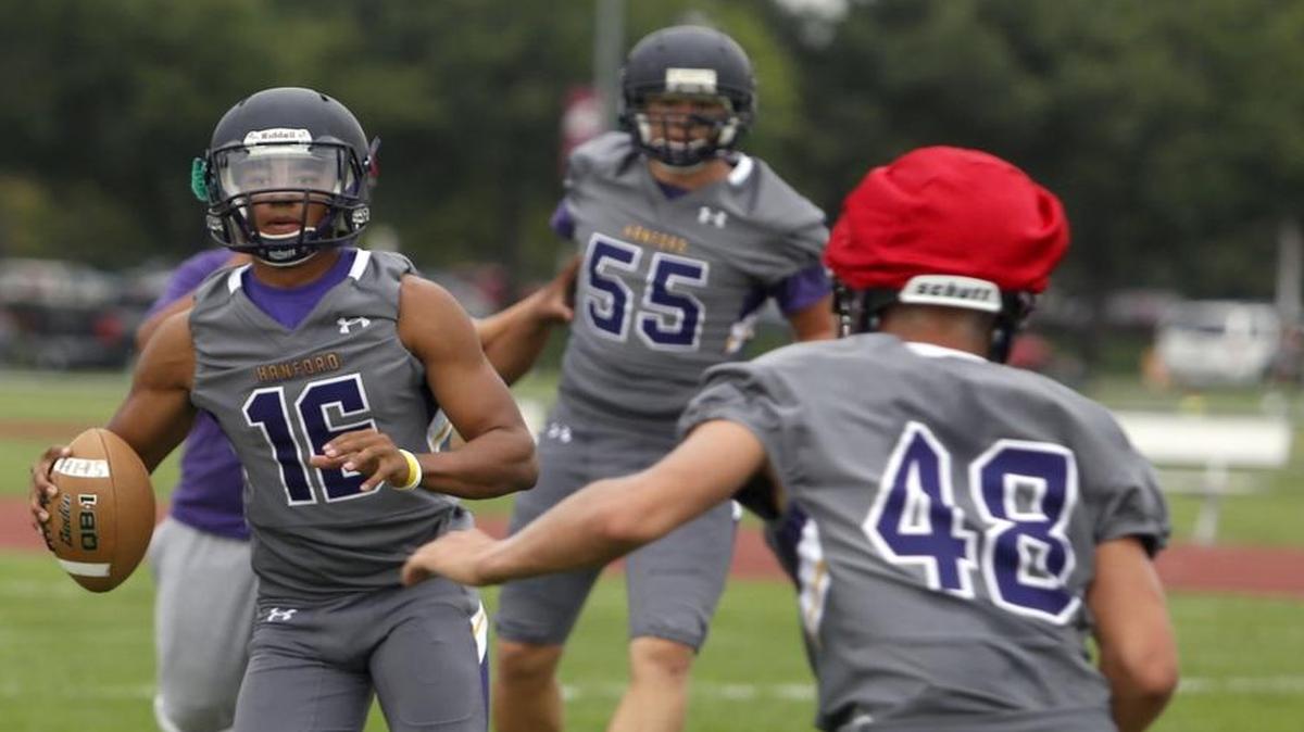 
Hanford High School junior Desmond Samples looks to throw the ball downfield during a preseason practice.
