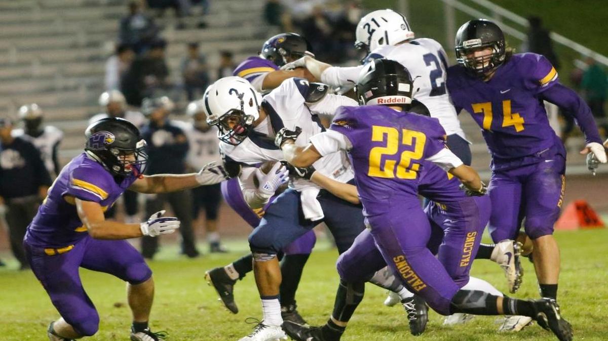 Chiawana’s Josiah Richardson (2) attempts to break away from Hanford.s defense during a football game on Friday at Fran Rish Stadium in Richland. Chiawana won 26-7.