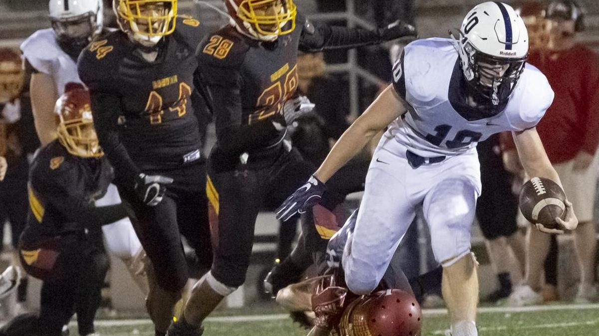 Chiawana’s Gabe Schilz breaks away from Kamiakin’s defense during a Mid-Columbia Conference football game at Lampson Stadium on Thursday. Chiawana won 42-0.