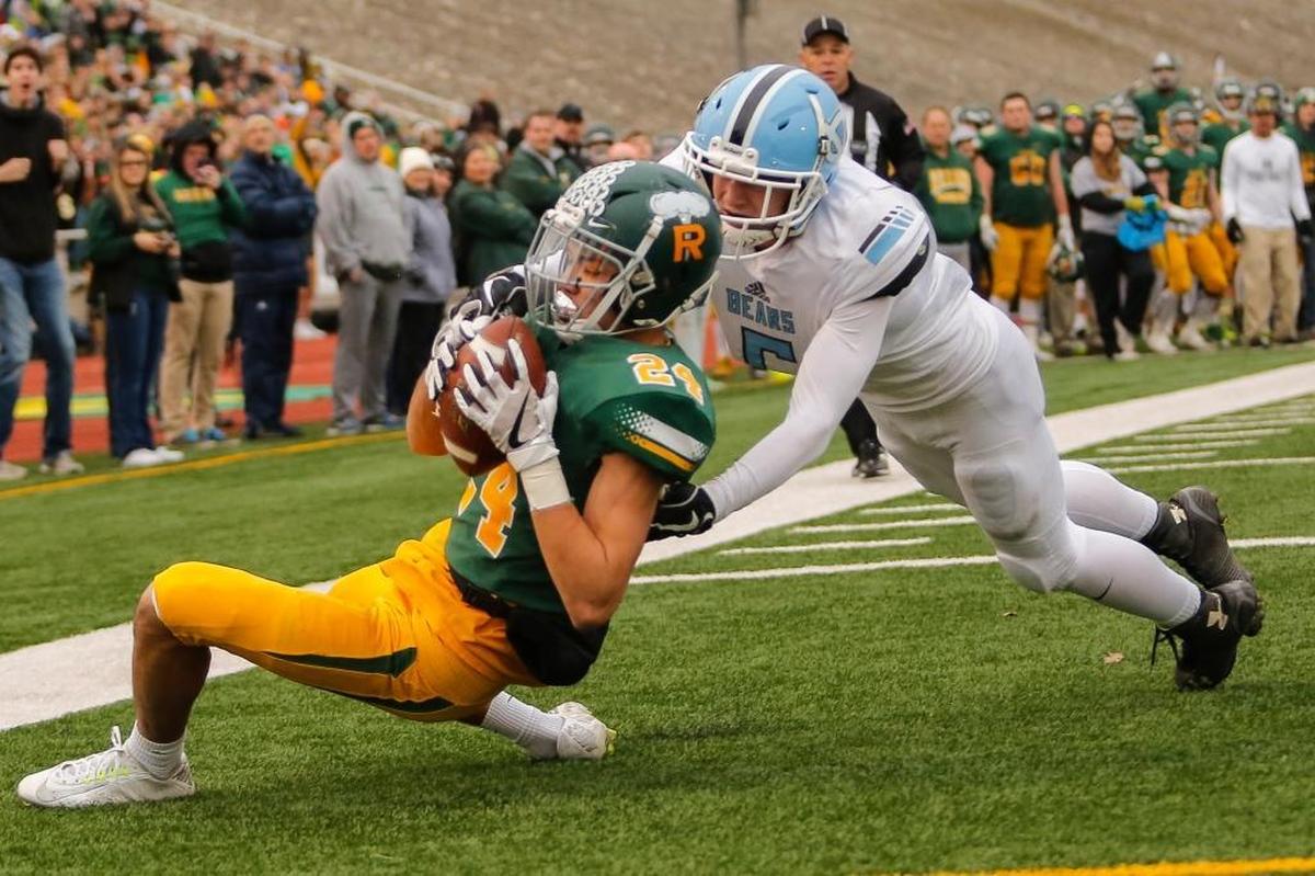 Richland's Sammy Cervantes (24) catches a touchdown pass from quarterback Cade Jensen (not pictured) as Central Valley's Josh Wilson (5) closes in during a WIAA 4A state semifinal game Saturday at Edgar Brown Memorial Stadium in Pasco. Richland defeated Central Valley 42-10.