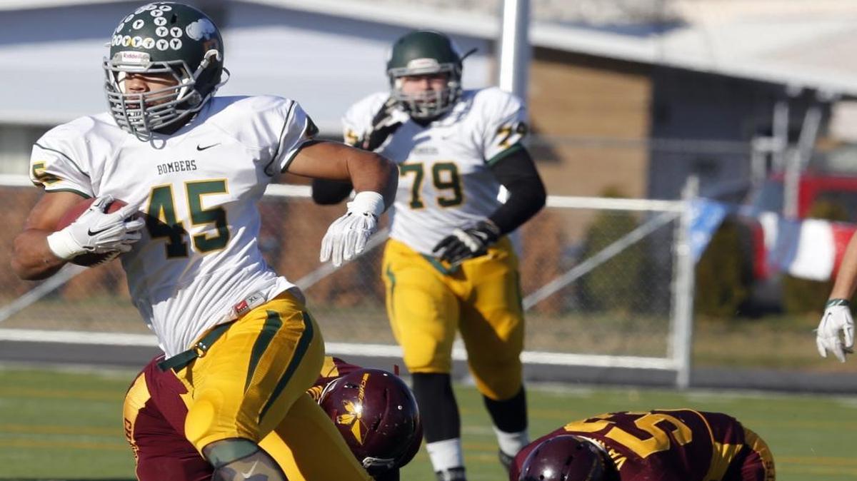 Richland High School’s Lakota Wills (45) leaves Moses Lake’s Juan Vasquez (53) and Brandon Pankratz, left, in the dust during Saturday’s Class 4A state quarterfinal at Lions Field in Moses Lake. Richland won 28-23 and will play Gonzaga Prep next week.