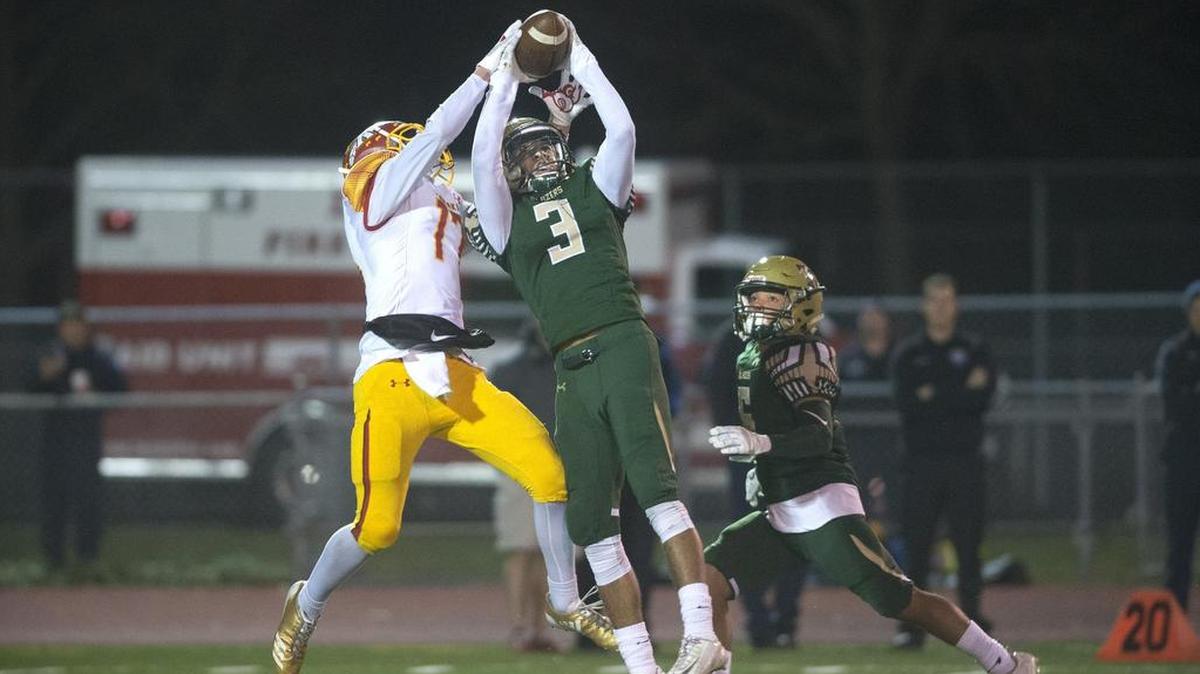 Timberline defensive back Isaac Thomson (3) intercepts a pass in front of Kamiakin wide receiver Champ Grayson (17) during Saturday night's opening-round game of the 3A state football playoffs at South Sound Stadium in Lacey. The Blazers beat the Braves 26-22.