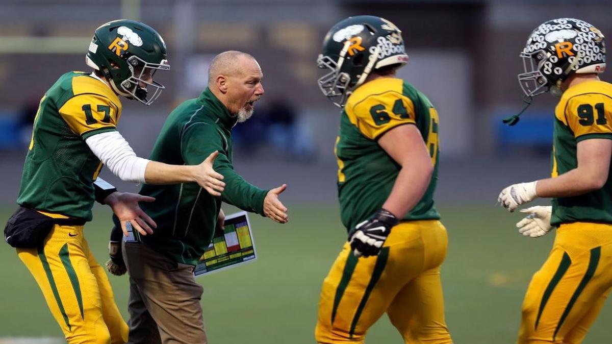 Richland football coach Mike Neidhold and quarterback Paxton Stevens (17) congratulate lineman Noah Sprenkle (64) and tight end/linebacker Jacob Stanfield (91) as they head back to the sideline while facing Skyview in a Class 4A state semifinal game Nov. 26 at Lampson Stadium. Like Stevens, Neidhold played quarterback for the Bombers, and in 1975 led them to their first state championship appearance. Richland lost to Foss 17-7 in that title game.