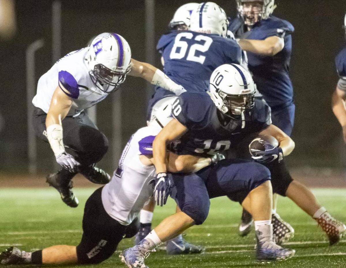 Chiawana’s Gabe Schilz (10) runs with the ball while being tackled by Hermiston’s defense duiring a Mid-Columbia Conference football game at Edgar Brown Stadium on Friday. Chiawana won 34-10.
