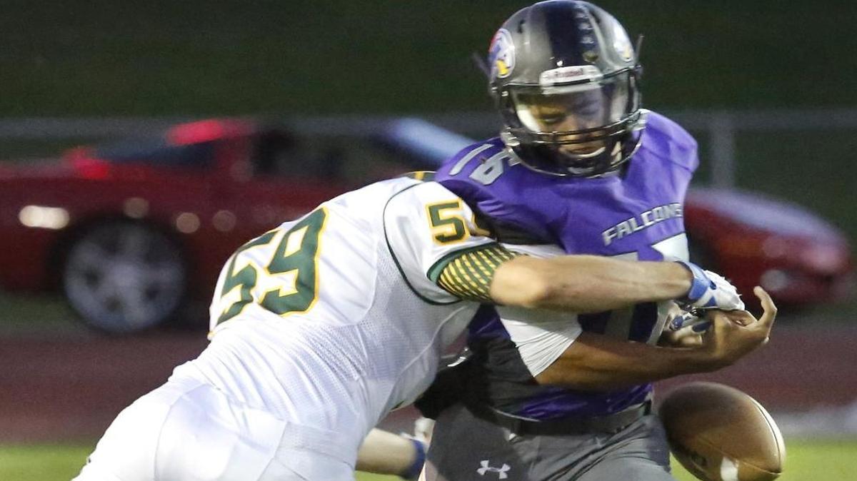 
Richland defender John Hardy (59) knocks the ball from Hanford quarterback Desmond Samples (16) on this first-quarter sack Friday night at Fran Rish Stadium.  See a photo gallery at tricityherald.com
