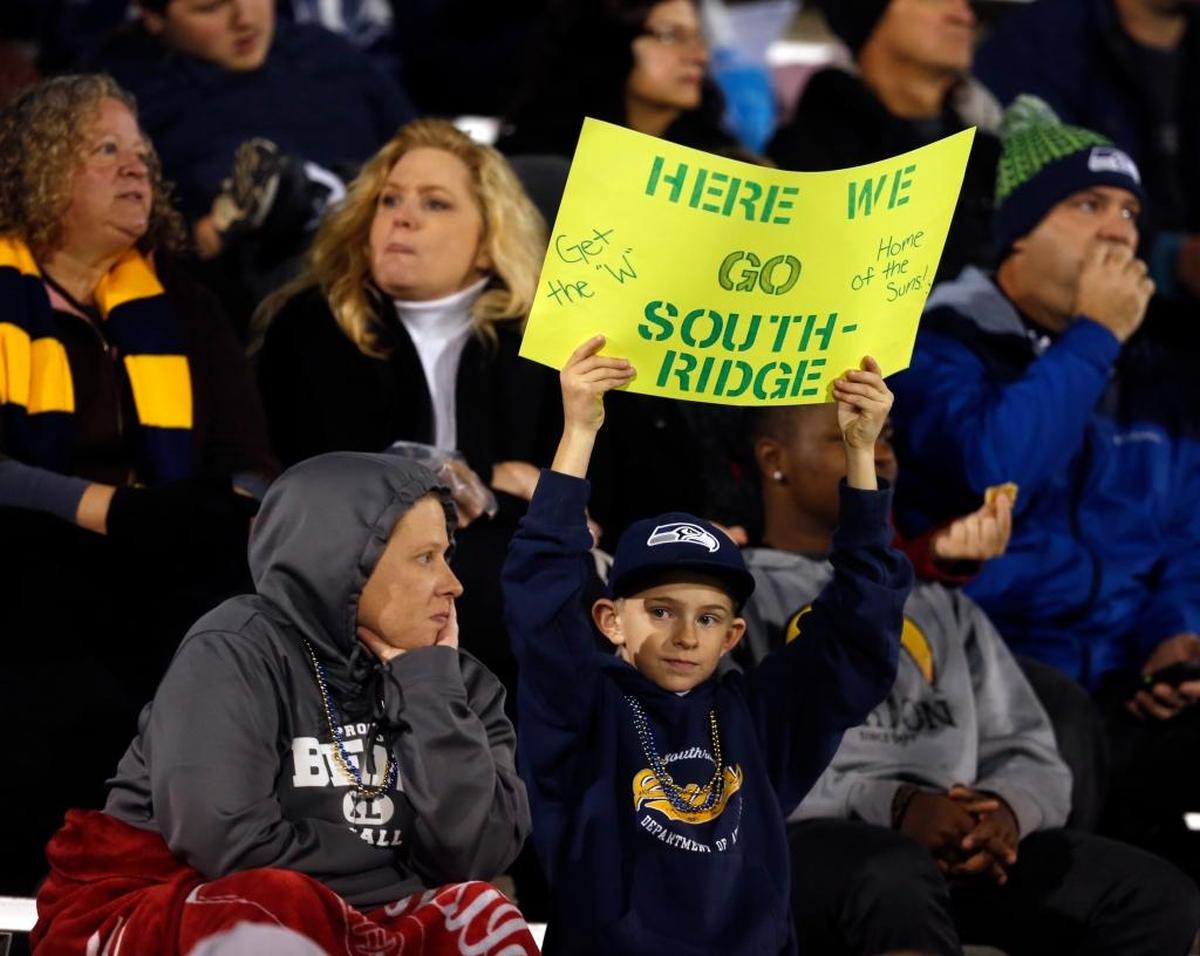 A Southridge High School fan holds up a sign during the Suns’ 44-20 crossover victory against Shadle Park during the 2016 season.