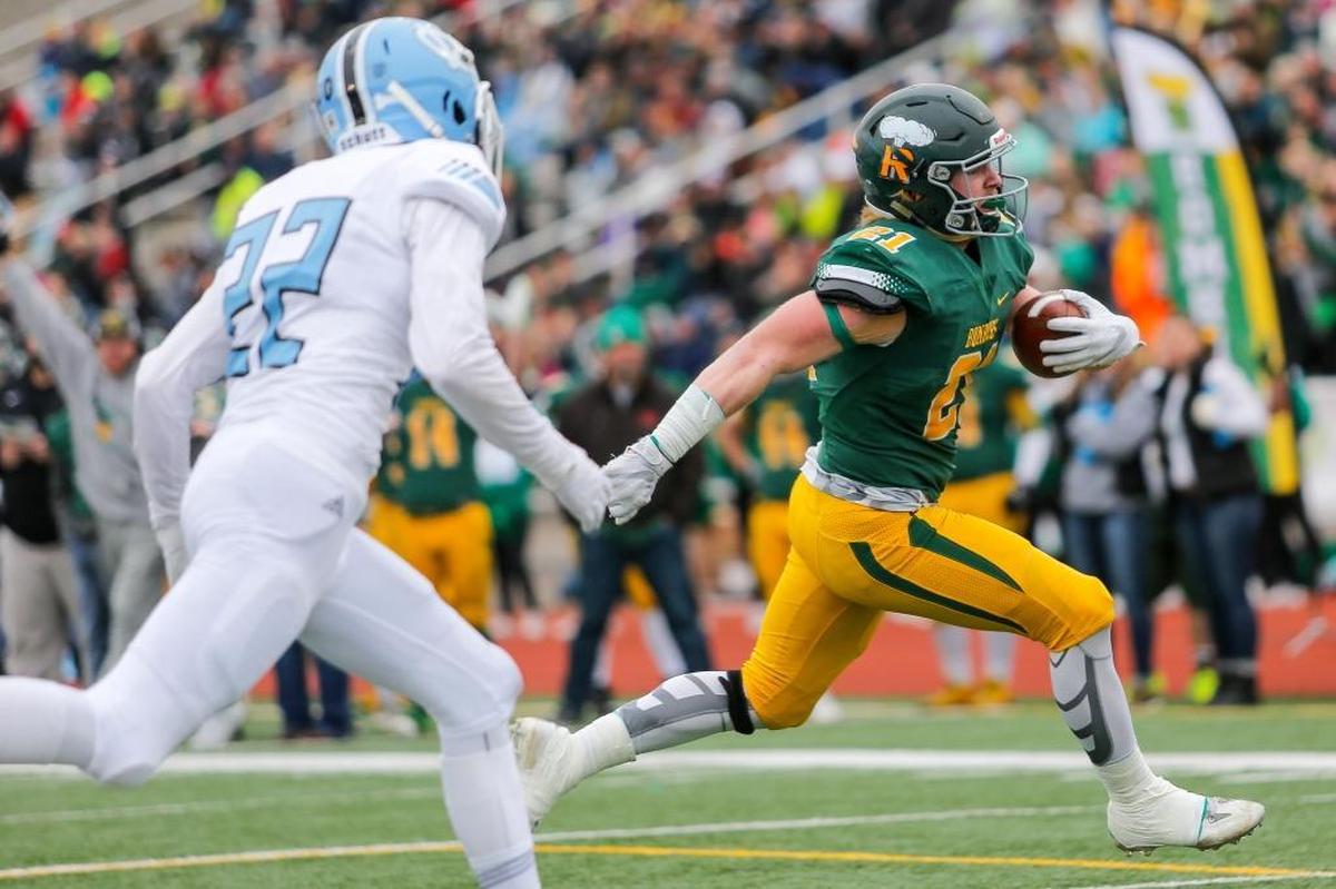Richland's Parker McCary (21) runs with Central Valley’s Jase Edwards (22) in pursuit during a WIAA 4A state semifinal game on Saturday at Edgar Brown Memorial Stadium in Pasco. McCary ran for 100 yards on 18 carries with a touchdown, as the Bombers beat the Bears 42-10.