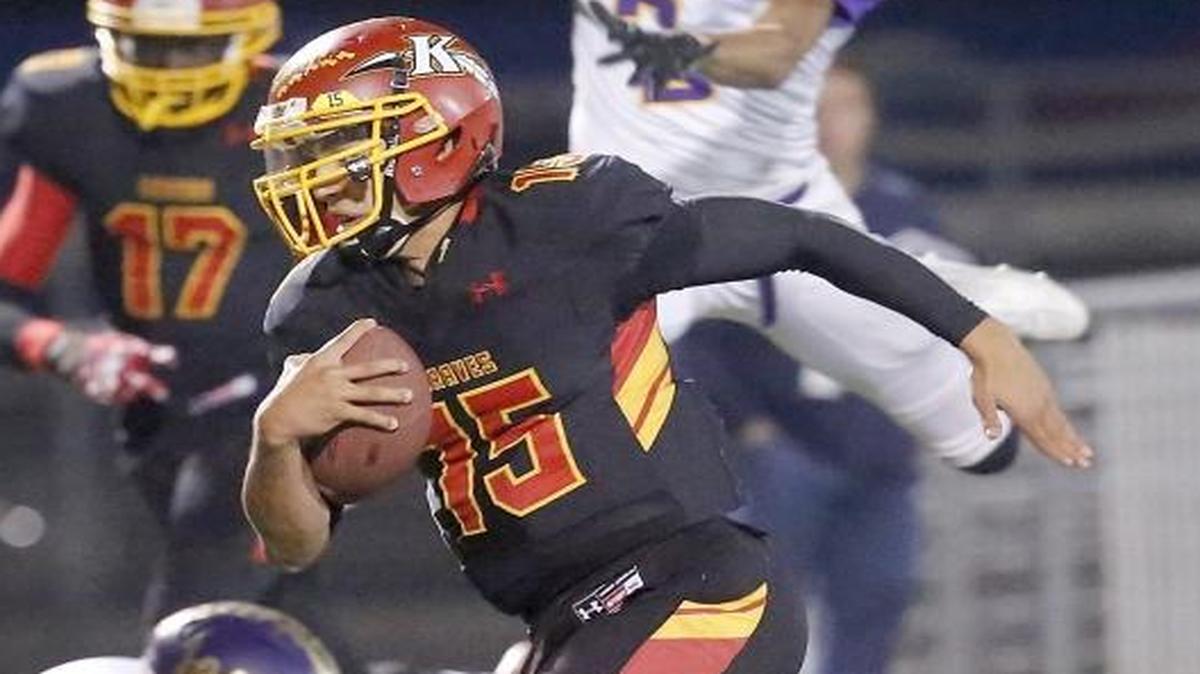 Kamiakin quarterback Zach Borisch (15) outruns a fleet of Rogers defenders on his way to scoring his second touchdown in the first half of Friday’s game at Lampson Stadium in Kennewick.