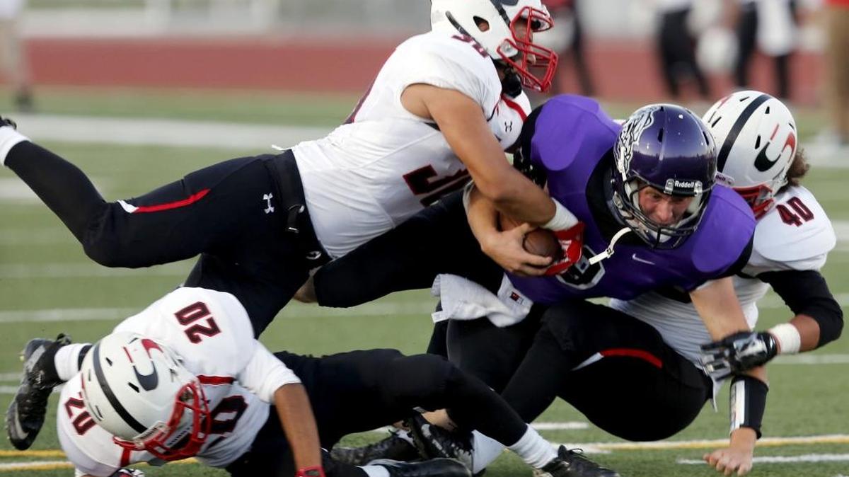 
Pasco quarterback Kolby Killoy (9) is tackled by Sunnyside defenders Fernando Cid-Reyes (20), Lorenzo Sanchez (30) and Alexis Valdez (40) on Thursday at Edgar Brown Memorial Stadium in Pasco. See more photos at www.tricityherald.com. 
