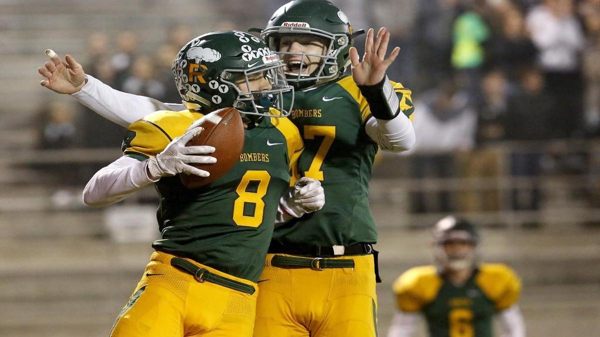 Richland wide receiver Alex Chapman (8) celebrates a first quarter touchdown with quarterback Paxton Stevens during Friday night's playoff game against Sunnyside at Lampson Stadium in Kennewick.