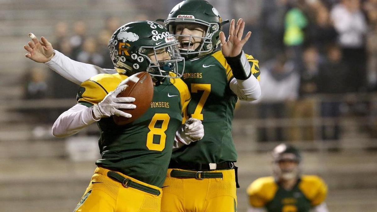 Richland wide receiver Alex Chapman (8) celebrates a first-quarter touchdown with quarterback Paxton Stevens during Friday night’s playoff game against Sunnyside at Lampson Stadium in Kennewick. Stevens threw six touchdown passes in the Bombers’ 41-0 win.