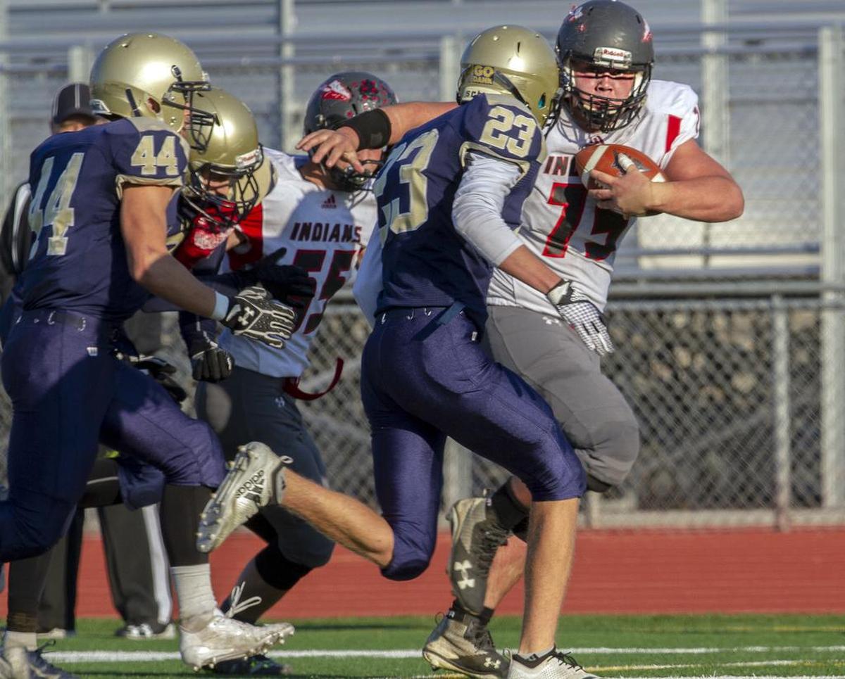 Tri-Cities Prep’s defense attempts to stop Toledo’s Hunter Eaton (75) as he carries the ball down the field during a playoff game on Saturday, Nov. 17, at Edgar Brown Stadium in Pasco. Toledo won 34-23.