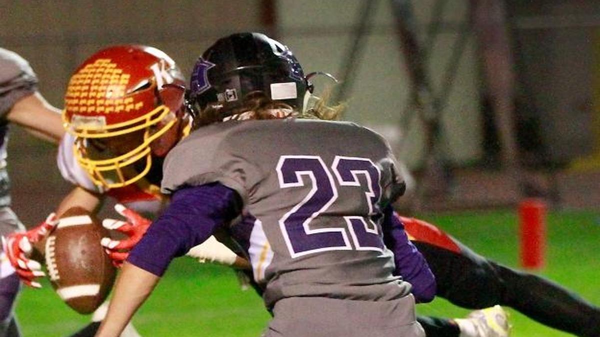 Kamiakin’s Benson Smith hauls in this pass for a diving touchdown catch Friday night as Hanford’s Joey Montoya (42) and Garret Werner (23) defend on the play.