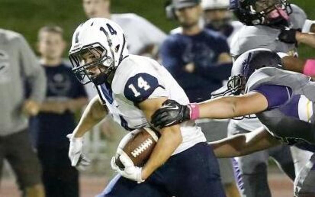 
Chiawana’s Andrew Vargas (14) fights for extra yardage on a run during Friday night’s game against Hanford in Richland.
