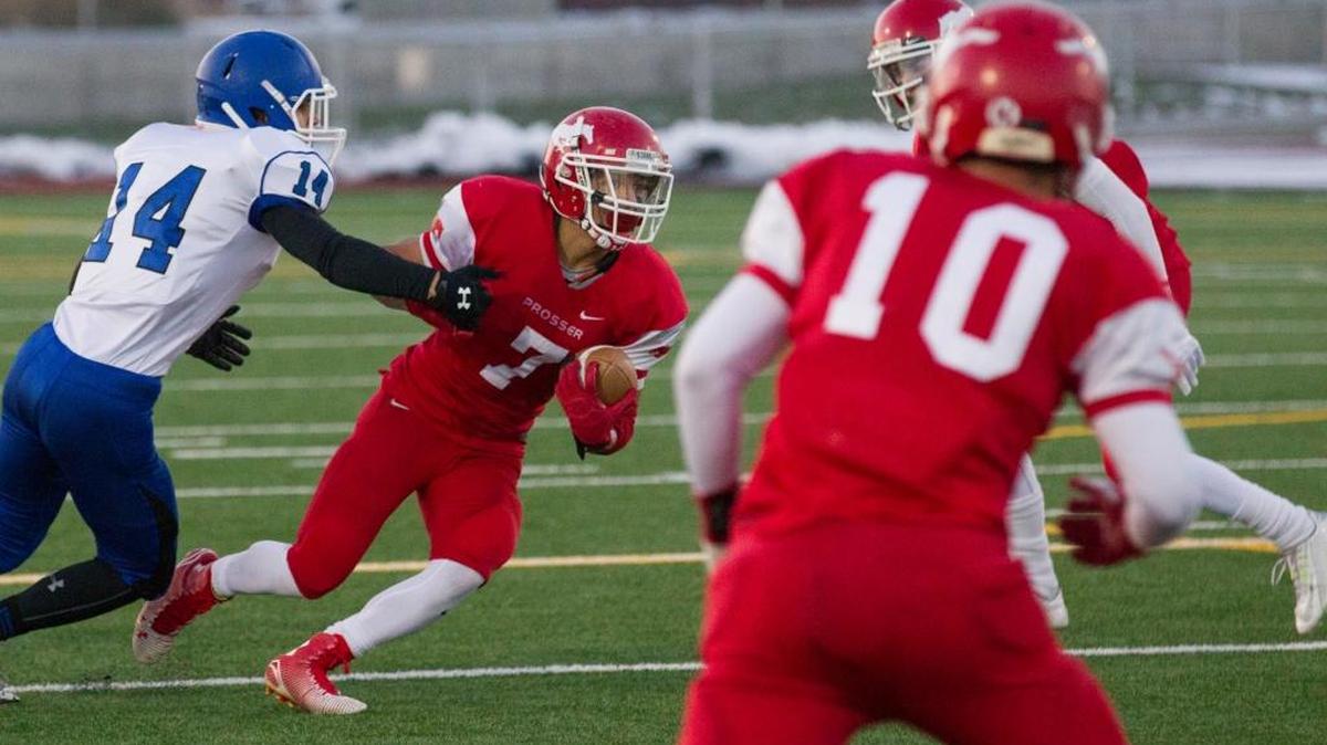 Prosser wide receiver Roy Borrego (7) eludes Sedro-Woolley defender Josh Gaethle (14) after catching a pass during the Mustangs’ 33-21 Class 2A semifinal victory over Sedro-Woolley on Saturday at Zaepfel Stadium in Yakima.