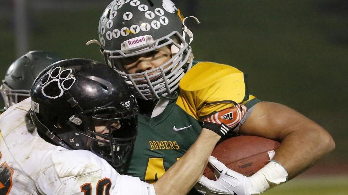 Richland’s Lakota Wills gets the best of Lewis & Clark defender Leo Haghighi during one of his runs Friday night at Fran Rish Stadium in Richland. See a photo gallery at tricityherald.com