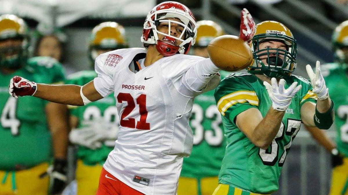 Prosser’s Michael Kernan (21) deflects a pass intended for Tumwater wide receiver Griffin Shea, right, in the first half of the Washington state 2A high school football championship on Saturday at the Tacoma Dome.