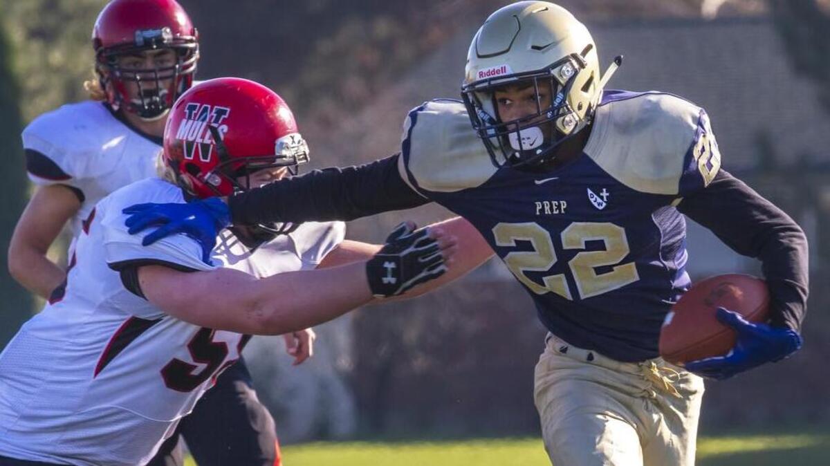 Tri-Cities Prep’s Kobe Singleton (22) slips away from Wahkiakum tackler Ashden Niemeyer during Saturday’s 2B playoff game at Chiawana High School in Pasco on Saturday, Nov. 10.