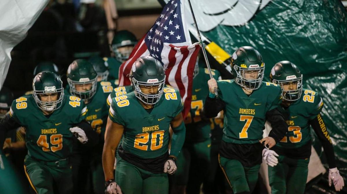 The Richland football team runs onto the field at Fran Rish Stadium before an MCC football game against Chiawana on Oct. 20. The MCC champ Bombers host GSL 4A No. 3 Mead at 7 p.m. Friday in a winner-to-state crossover game