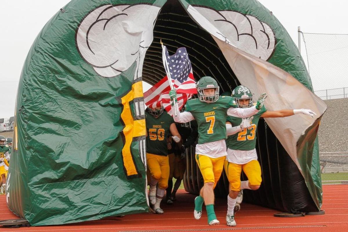 Richland seniors Adam Weissenfels (7) and Josh Mendoza (23) lead the Bombers onto the field before their semifinal game against Central Valley on Nov. 25. The Bombers won 42-10.