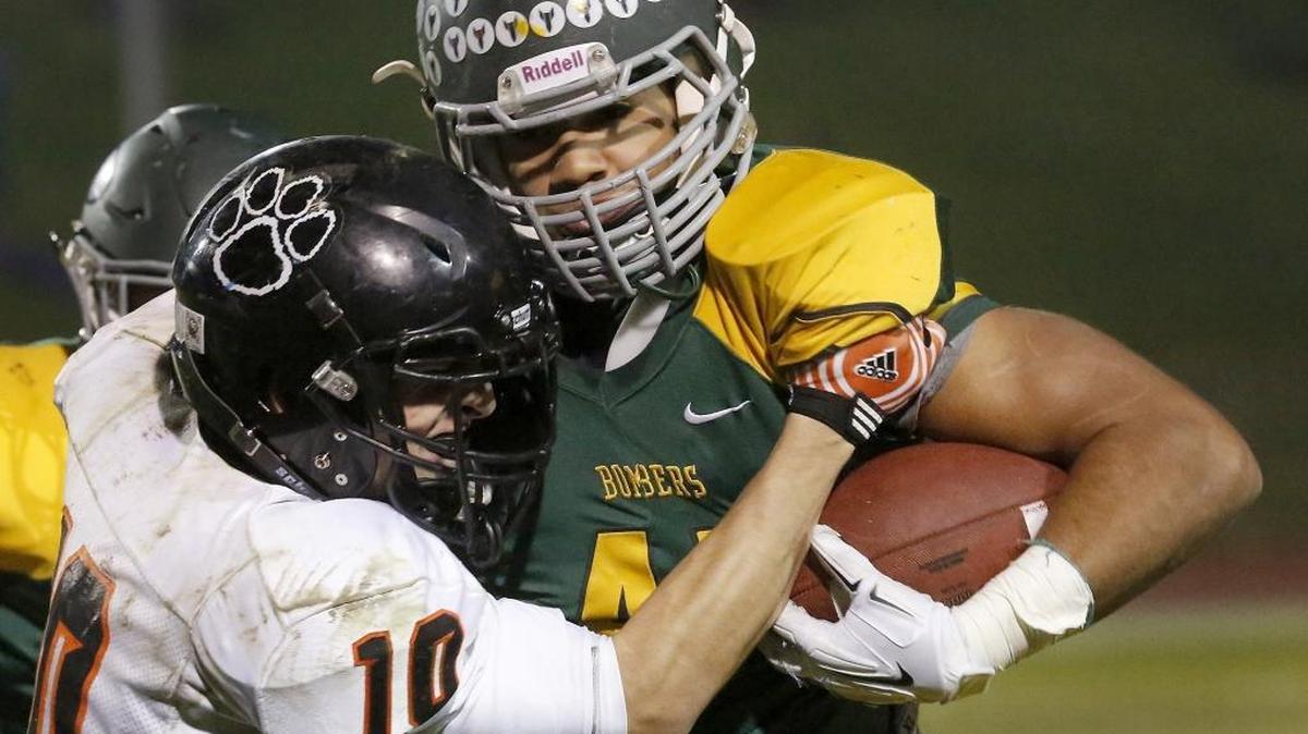 Richland’s Lakota Wills gets the best of Lewis & Clark defender Leo Haghighi during one of his runs Friday night at Fran Rish Stadium in Richland.